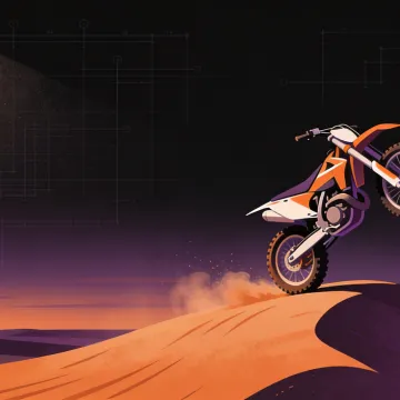 A dirt bike holds a controlled wheelie on a ridge at dusk.